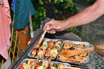 Homemade barbecue at the cottage with meat bacon and vegetables