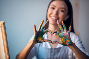 Selective focus of female hands in paint
