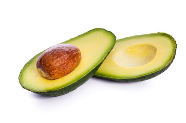 Two fresh slices of avocado with core isolated on a white background in close-up. 