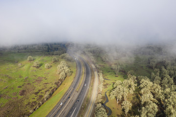 A highway disappears under a low blanket of clouds in central Oregon.