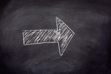 Blank drawn arrow with chalk on a blackboard