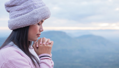 Thai women pray for the blessing of God at sunrise.