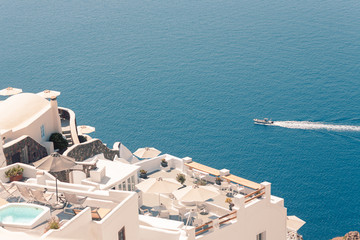 Fototapeta na wymiar View on the seaside of Santorini island with ship on the sea