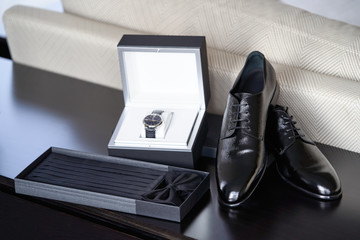 Groom wedding set with shoes wristwatch bow tie, close-up