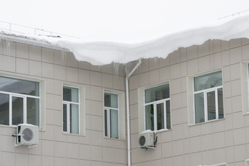 Snow covered roof of a city house