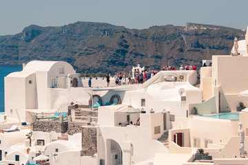 Fototapeta na wymiar Classical view on the decoration and architecture of Oia village Santorini at sun weather