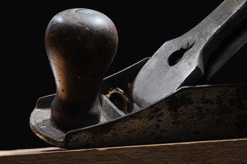 Old carpenter's plane with wooden handle studio shot
