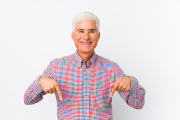 Senior caucasian man isolated points down with fingers, positive feeling. © Asier