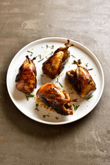 Roasted quails on plate