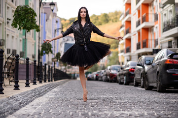 Elegant ballet dancer young girl dancing ballet outdoors.