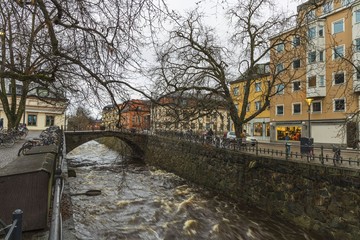 Gorgeous view on  street near river on background. Gorgeous sky with thunderclouds on a winter day.  Tourism, travel concept. Europe, Sweden, Uppsala.