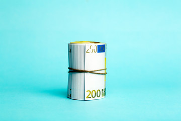 Money and income concept. Euro cash banknotes on a blue background. Saving and spending money