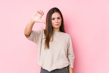 Young caucasian woman posing isolated showing a dislike gesture, thumbs down. Disagreement concept.