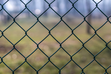 Fototapeta premium Chain Link Fence With Blurred Background