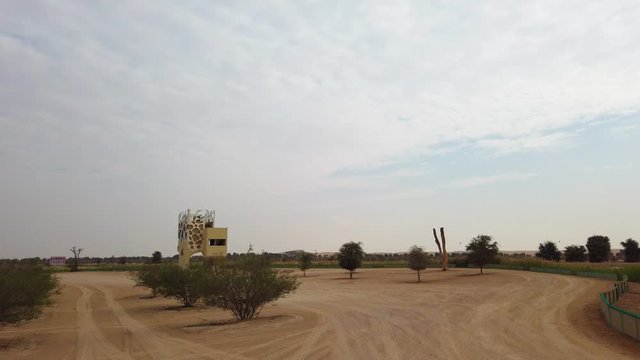 Quiet landscape with waterfront observing tower near Al Quadra Lake banks in Dubai, a natural habitat for birds, pan view