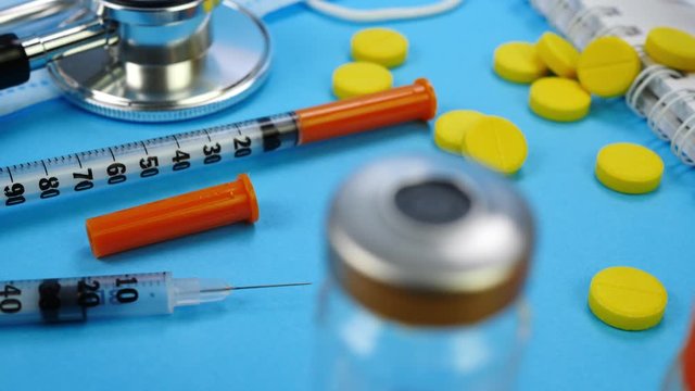 Medicine Vaccination Equipment with Needle. Insulin syringe for insection, yellow pills, stethoscope, vaccine bottles, paper notebook. Health care, doctor, clinic or hospital. Health care in hospital
