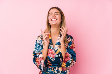 Young caucasian woman wearing pajamas joyful laughing a lot. Happiness concept.