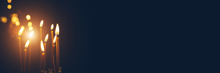 burning church candles on a dark background