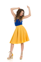 Carefree Woman Is Dancing In Platform Shoes And Vibrant Clothes