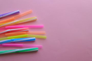 Fototapeta premium Plastic cocktail straws on color background