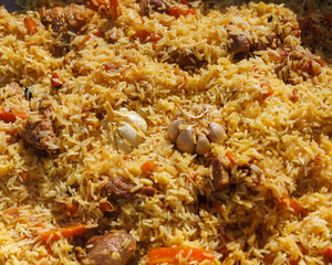A series of the process of cooking pilaf in a cauldron on the street. handmade oriental cuisine. finished dish close-up.
