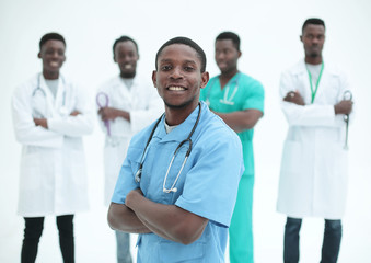 young medic standing in front of his friends colleagues