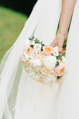 Obraz na płótnie Canvas delicate wedding bouquet in the bride's hand