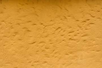 Yellow plaster, rough wall texture, background