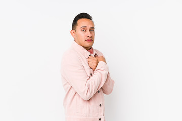 Young latin man posing isolated scared and afraid.