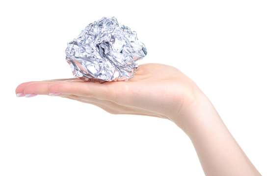 Crumpled ball of aluminum foil in hand on white background isolation