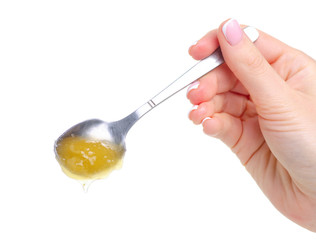Spoon with honey in hand on white background isolation