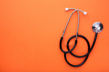 Medical stethoscope on a orange background. Health care concept