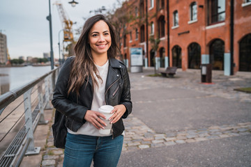 Young woman holding a cup of coffee.