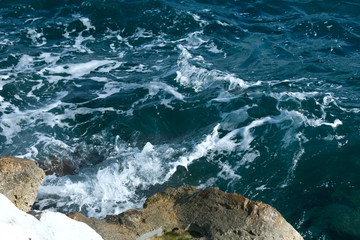 Wavy sea water surface and rocks