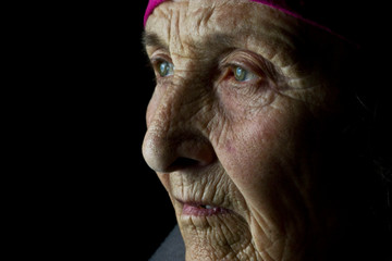 Old face with wrinkles closeup. Grandmother's face close-up. Eyes close-up on the face of an old...