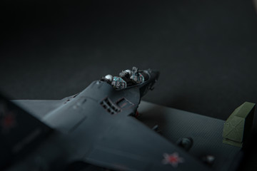 Miniature of military fighter without pilot cabin on a black background with place for text