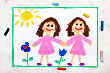 Obraz na płótnie Canvas Photo of colorful drawing: Identical twins. Two smiling sisters look the same