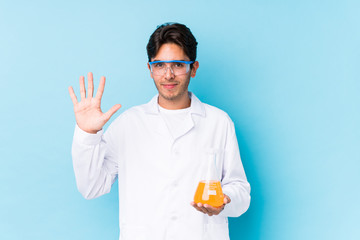 Young cientific caucasian man isolated smiling cheerful showing number five with fingers.