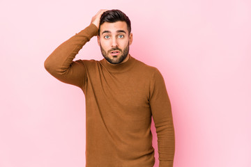 Young caucasian man against a pink background isolated tired and very sleepy keeping hand on head.