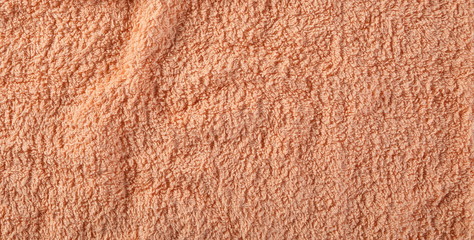Orange crumpled textile, terry cloth background and texture