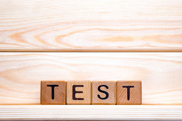 Test word made of wood background. Business concept. Test sign, exam, learning concept. Word test written with wooden cubes. Education quality control. Test background