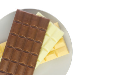  tiles with milk, caramel and white chocolate on a gray plate isolate on a white background.Flat lay 