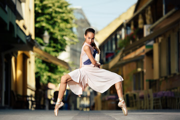 Fototapeta na wymiar Young Ballerina Dancing On The Street