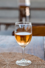 Glass of white wine on wooden table