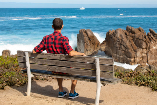 Scenic Monterey coast, travel man enjoying beautiful view of the Kissing Rock, Pacific Grove, Monterey, California, USA
