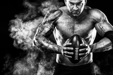 Fototapeta na wymiar Sport concept. American football sportsman player on black background. Sport concept.