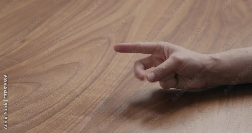 Wall mural Slow motion man hand counting on black walnut table - Wall murals