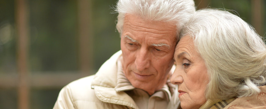 Close Up Portrait Of Sad Thoughtful Senior Couple