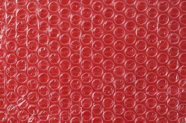Bubble wrap on red background and plastic texture