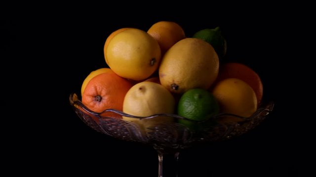 Citrus fruits: lot of lemon, oranges and limes top view. Rotate. Assorted citrus in basket